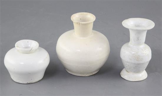 A Chinese Dehua white glazed bottle and two Dehua white glazed vases, Yuan-Ming dynasty, 5.7cm - 9.3cm